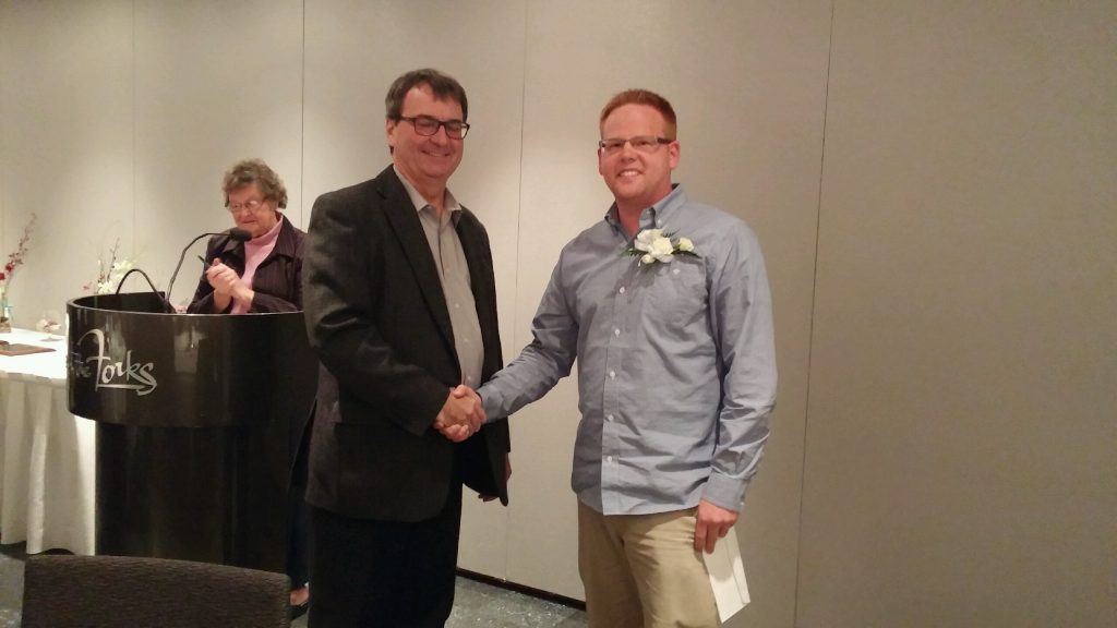 Ryan Greenham receiving the Kay Armstrong Scholarship from Kay's son Glenn Armstrong. (Photo sent in by Ryan Greenham)